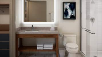 A modern bathroom with a sink, mirror, toilet, and shower.