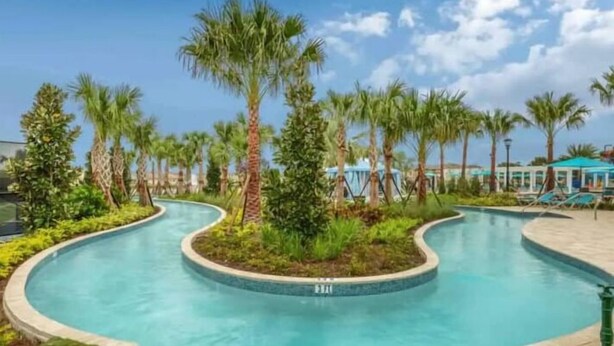 A pool area with palm trees and lounge chairs. - Dazzling 9BR Villa with Pool& Spa, Close to Disney (Four Corners)