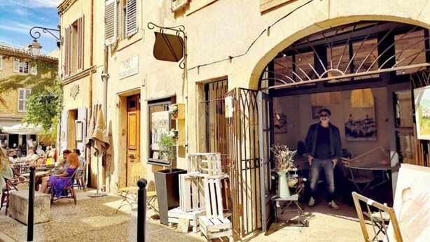 A street with a gallery named "Galerie Marche" displaying paintings.