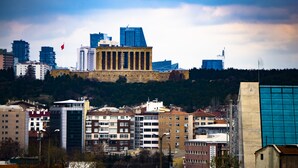 A cityscape with a prominent historical building in the center, surrounded by modern high-rise buildings. - Ankara Santral Otel (Ankara)