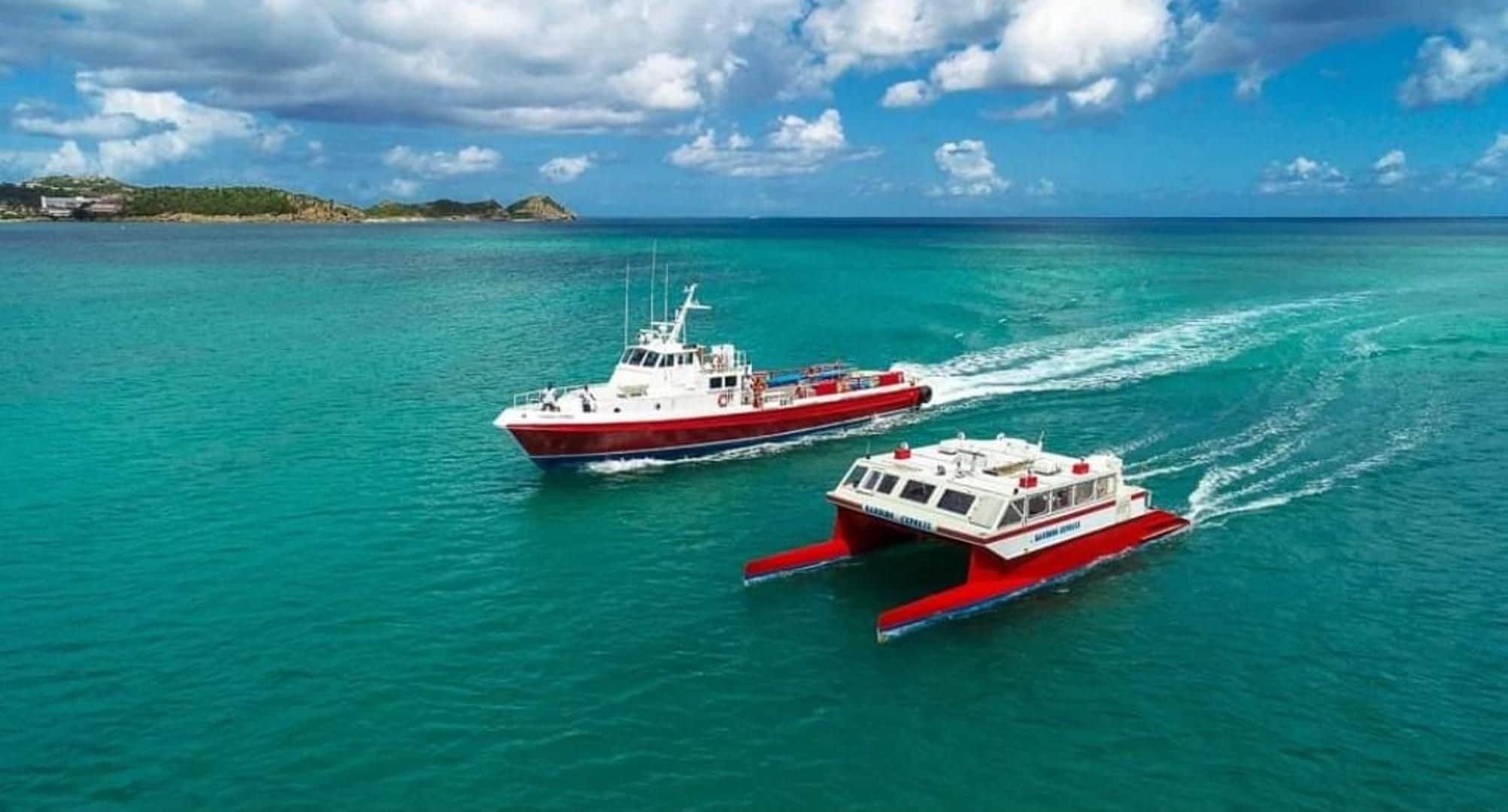 Two boats on turquoise water with a clear sky.