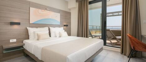 A modern hotel room with a large bed, a balcony with a view, and a contemporary design.