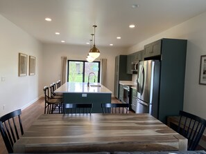 Enjoy meals in the kitchen with a central island, sink, and dining area overlooking the garden.