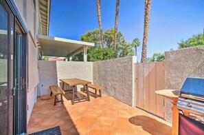 Enjoy dining and socializing in this patio area with a barbecue grill and comfortable seating.