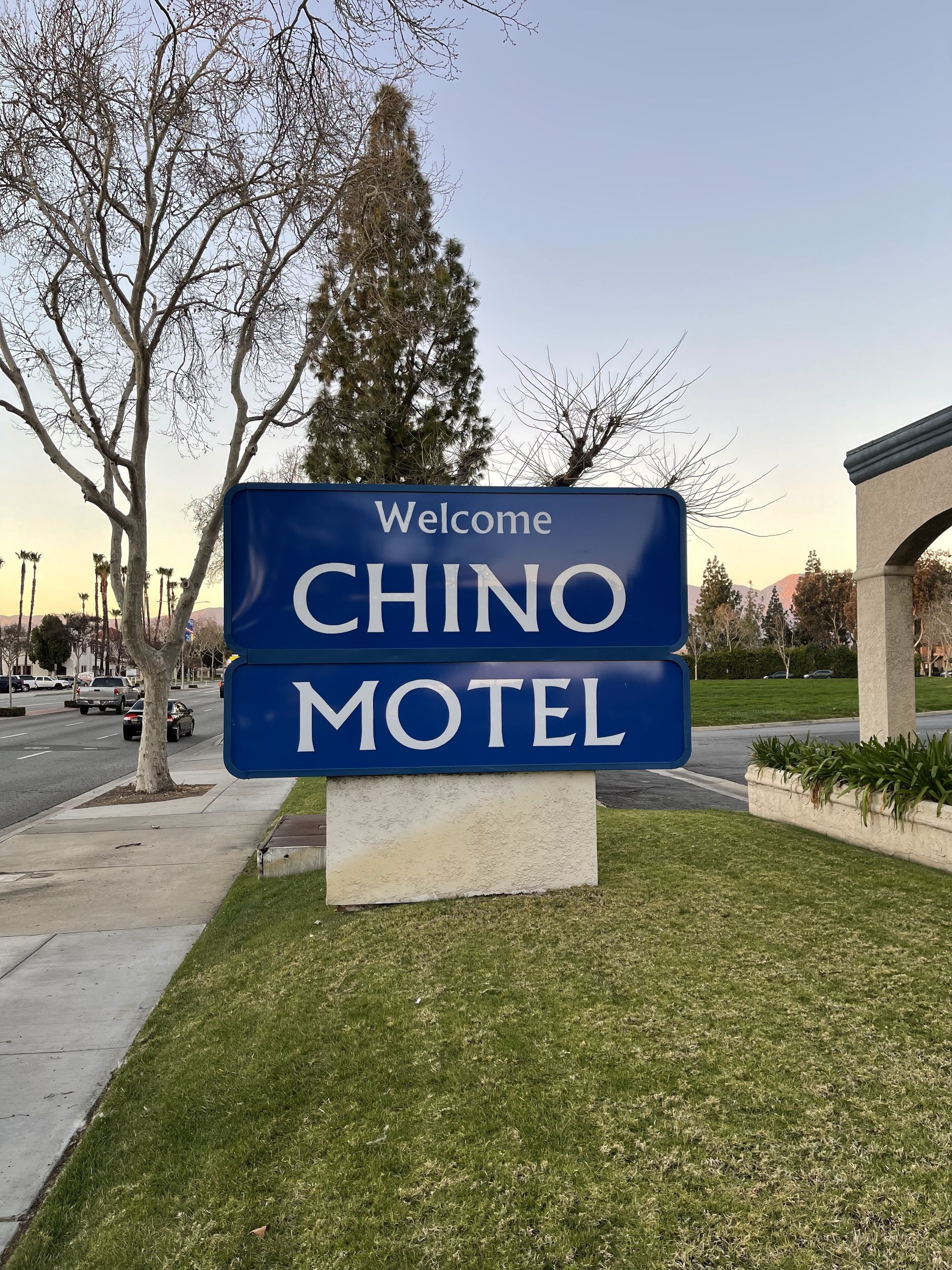 A blue welcome sign for CHINO MOTEL.