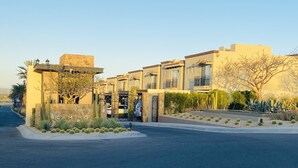 A modern residential complex with multiple two-story houses, a gated entrance, and landscaped with cacti and shrubs. - HOUSE OF THE SEA, fraction. private with pool, by car 7 minutes from the beach and downtown (Cabo San Lucas)