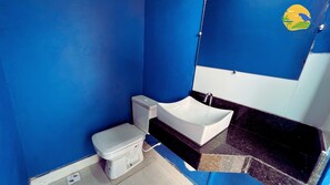 A bathroom with a toilet, a bidet, and a sink.