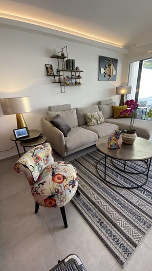 A modern living room with a sofa, armchair, coffee table, and decorative items. - Superb house with sea-view terrace 300 m from the beach. (SANT AMBROGGIO LUMIO)