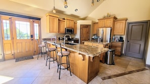 Enjoy cooking in this well-equipped kitchen with a large island and stainless steel appliances.