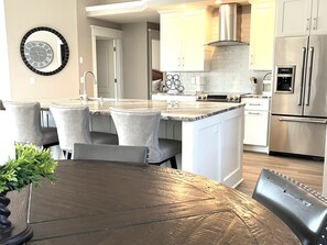 Enjoy cooking in this well-equipped kitchen with a central island, oven, and stainless steel range hood.