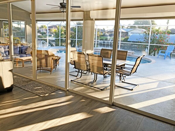 Relax in this open-plan living space with an outdoor area featuring a pool and patio.