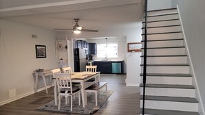 A modern kitchen with dark wood cabinets, a built-in oven, and a window above the sink. - Sunset Beach Bliss| Walk to Beach & Waterpark (Ocean City)