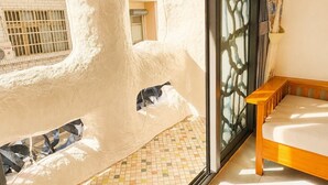 A room with a large window, a bench, and a tiled floor. - Dory Hostel  (Liuqiu)
