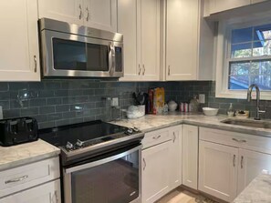Microwave, dishwasher, coffee/tea maker, cookware/dishes/utensils