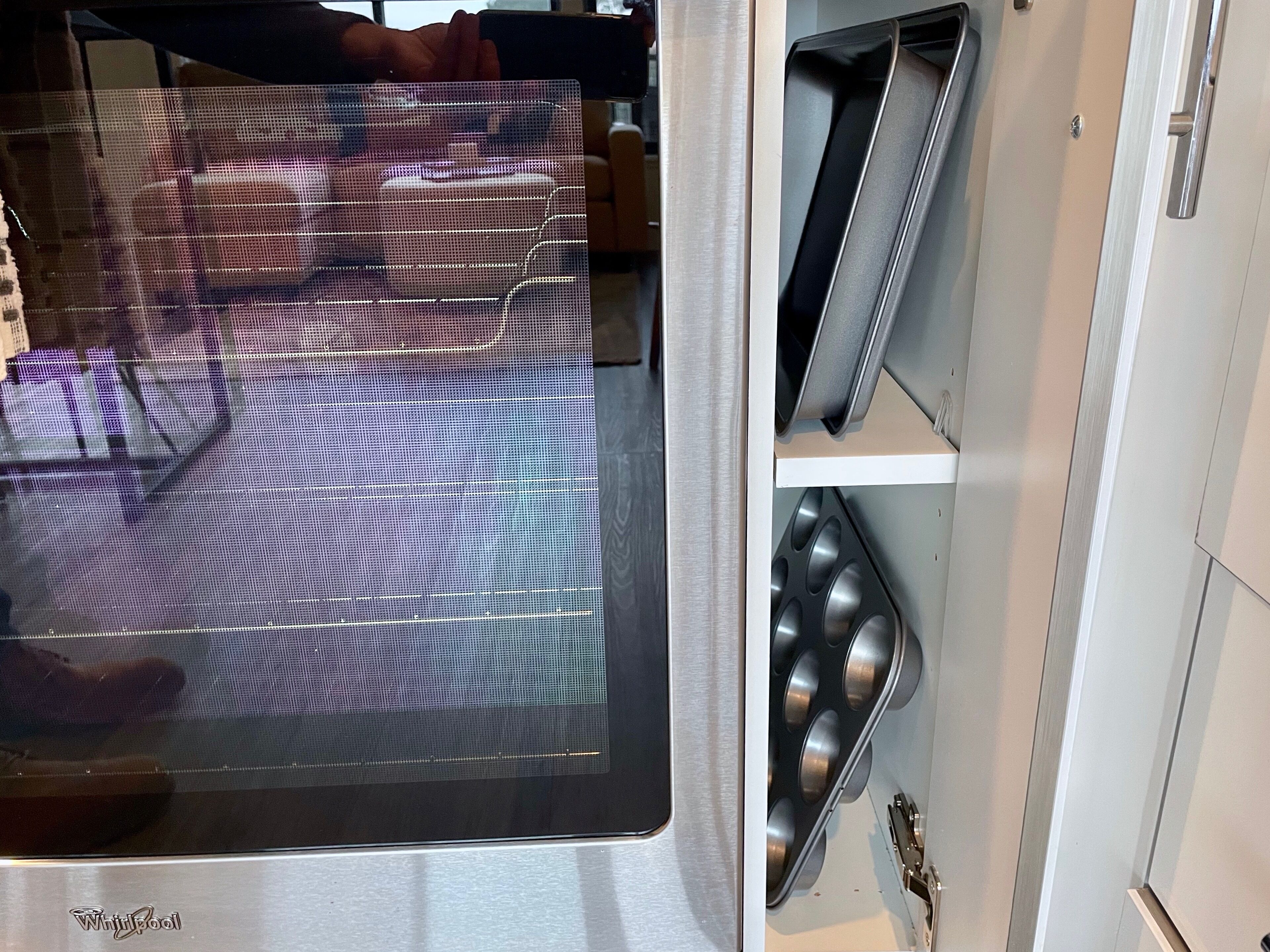 A kitchen with a stainless steel refrigerator, a microwave, and a built-in oven.