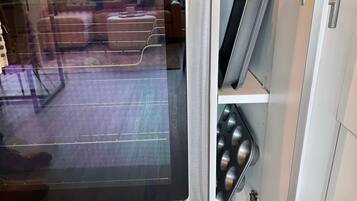 A kitchen with a stainless steel refrigerator, a microwave, and a built-in oven.