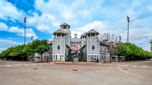A large, two-story building with a central tower and two smaller towers on either side. - Downtown Frisco Gem (Frisco)