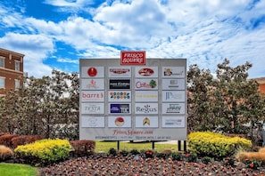 A signboard with various business logos, including a prominent "FRISCO SQUARE" sign at the top. - Downtown Frisco Gem (Frisco)
