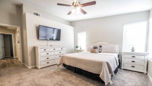 A bedroom with a bed, a dresser, a nightstand, a ceiling fan, and a TV on the wall. - Vegas Vacation Home ... Close to The STRIP (North Las Vegas)