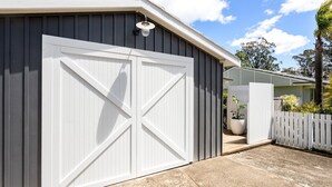 A garage with a white door and a light fixture above it.