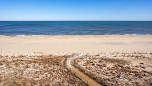 A beach with a sandy shore and a clear blue sky.
