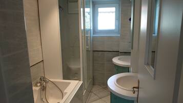 Combined shower/tub, hair dryer, toilet paper