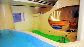 Swimmers can enjoy the pool surrounded by curved walls and a window for natural light.