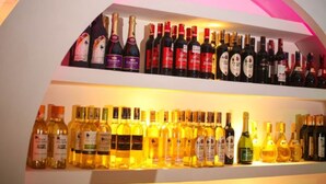 A wine rack with various bottles of wine.
