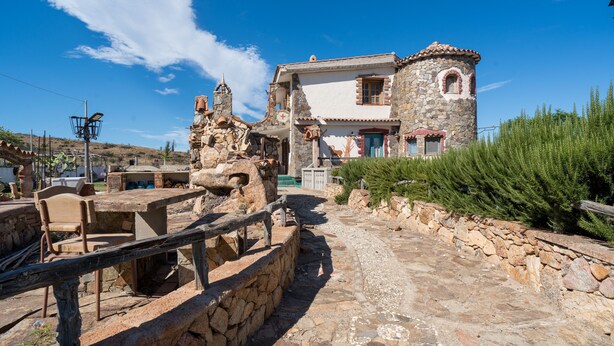 A stone building with a tower, a paved pathway, and a wooden fence. - Studio 'Sa Burrida' Relax close to the Sea with Garden & Wi-Fi (Posada)