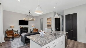 A modern kitchen with granite countertops, a built-in sink, and pendant lighting. - Elvis`s Rooftop - Brand New Nashville Hang Out (Nashville)