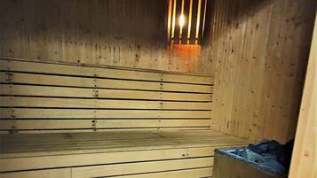 A wooden room with a sloped ceiling and a tiled floor.