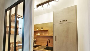 A modern kitchen with wooden cabinets, a sink, and a countertop.