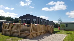 A wooden deck with a sign reading "Wissell View" leading to a cabin with large windows and a covered porch. - Beautiful 2-bed Lodge Ribble Valley Clitheroe (Clitheroe)
