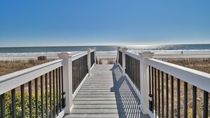 A wooden walkway leading to a beach with a clear sky. - Crescent Keyes 810 | Oceanfront 3 Bedroom Condo (North Myrtle Beach)