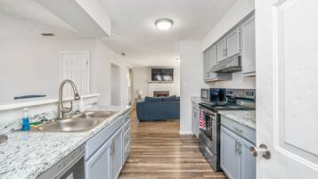 Microwave, dishwasher, coffee/tea maker, cookware/dishes/utensils