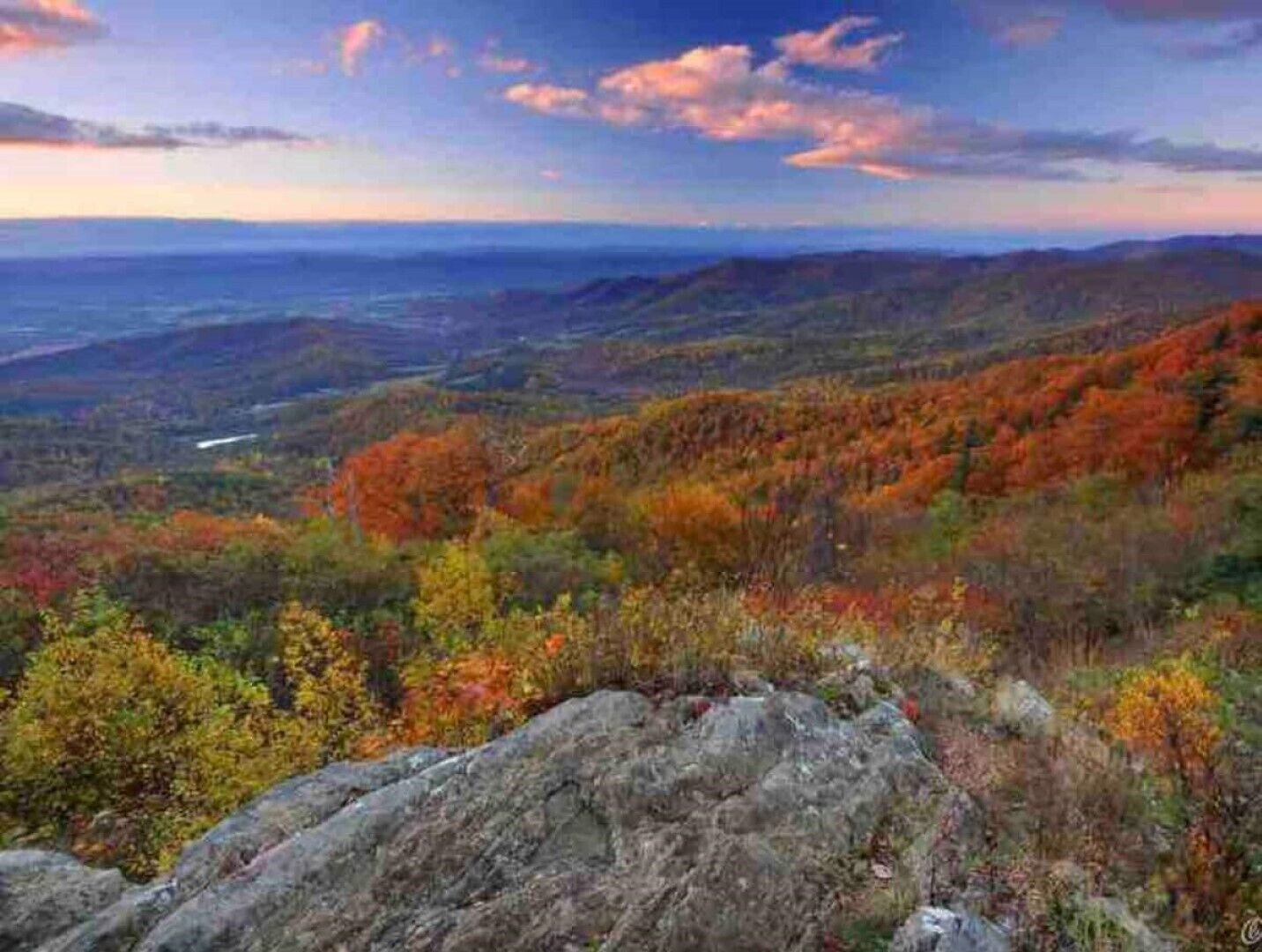 A mountainous landscape with autumn foliage.