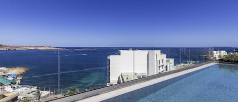 Seasonal outdoor pool, open 7:00 AM to 8:00 PM, pool umbrellas