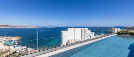 Seasonal outdoor pool, open 7:00 AM to 8:00 PM, pool umbrellas