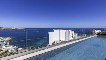 Seasonal outdoor pool, open 7:00 AM to 8:00 PM, pool umbrellas