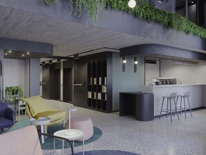 A modern lounge area with a sofa, chairs, a small table, a bar area with stools, and a bookshelf. - Ibis Styles St. Paul's Bay Malta (St. Paul's Bay)