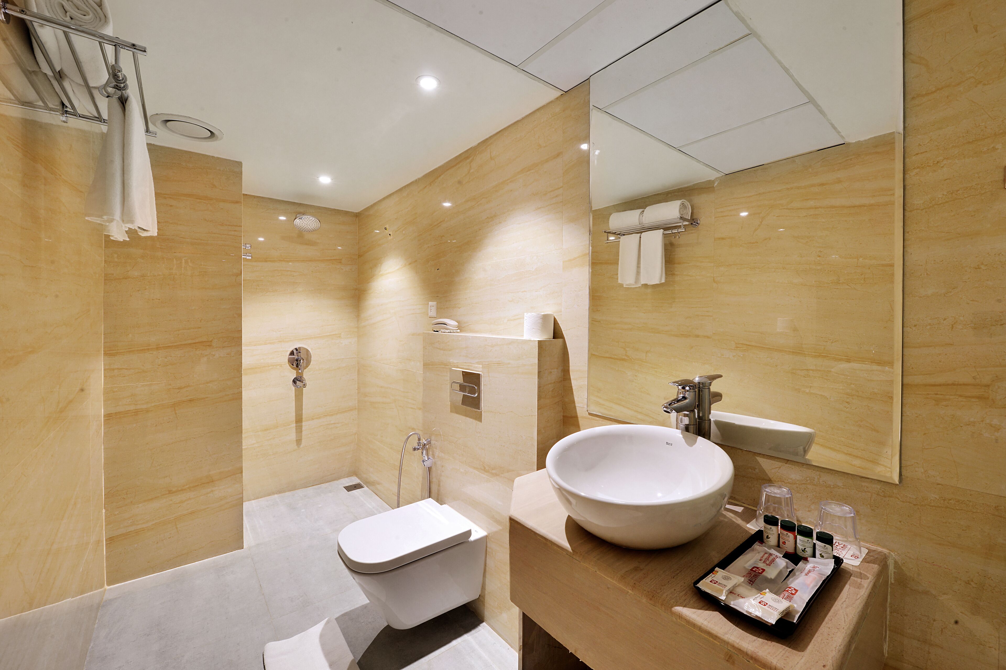 A modern bathroom with a bathtub, toilet, and sink.