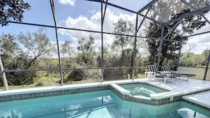 A swimming pool with a glass enclosure, lounge chairs, and a view of the surrounding landscape. - Palace Retreat - Private Pool/Spa & 24/7 Support (Davenport)