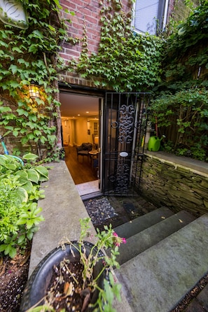 A brick building with a door leading to an interior space. - One Such Boston Gem w Pvt Garden (Boston)
