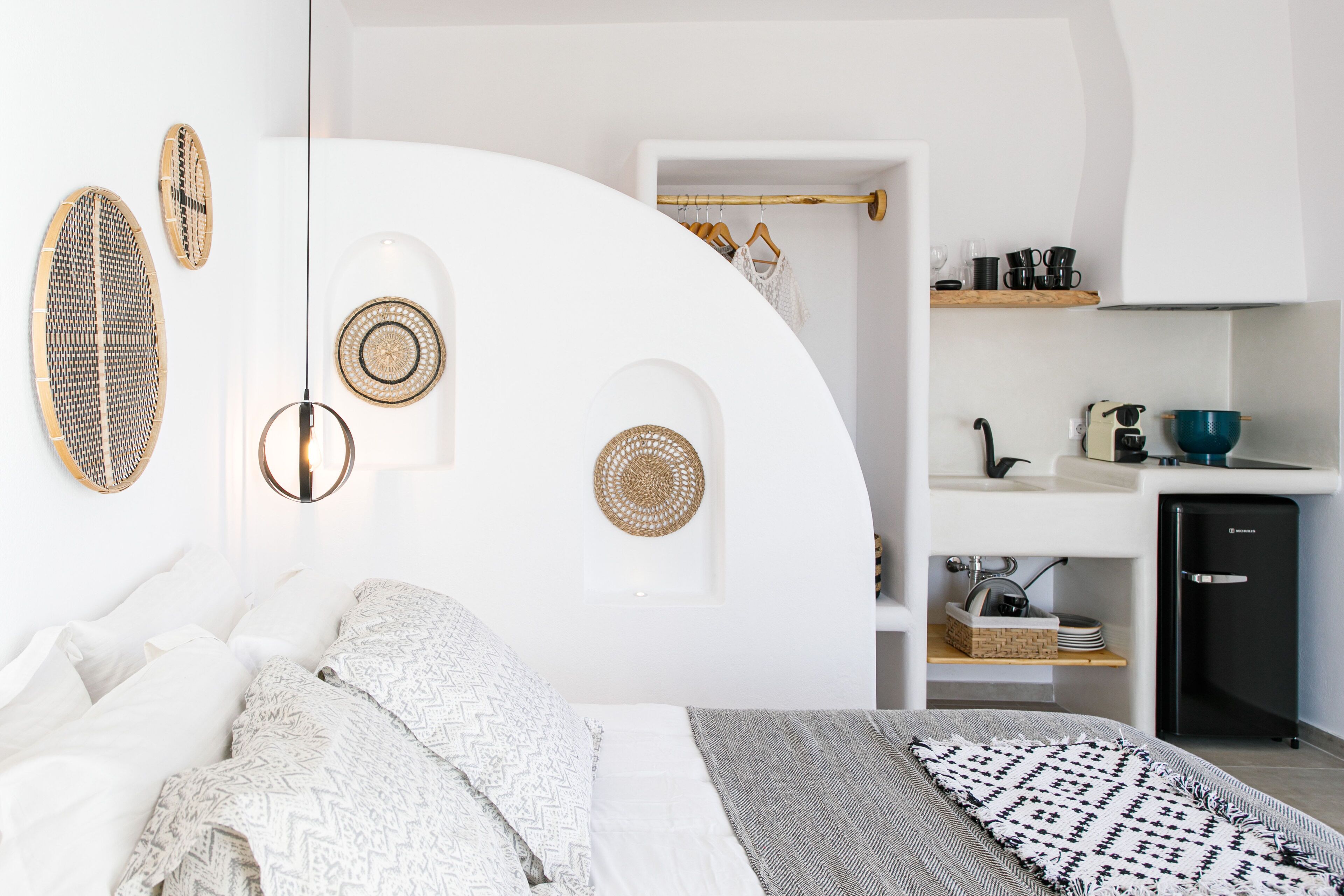 A modern bedroom with a bed, bedside tables, and a built-in wardrobe.