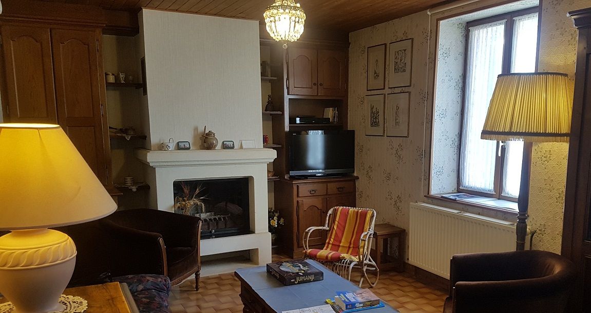 Una sala de estar acogedora con chimenea, televisor y asientos cómodos.