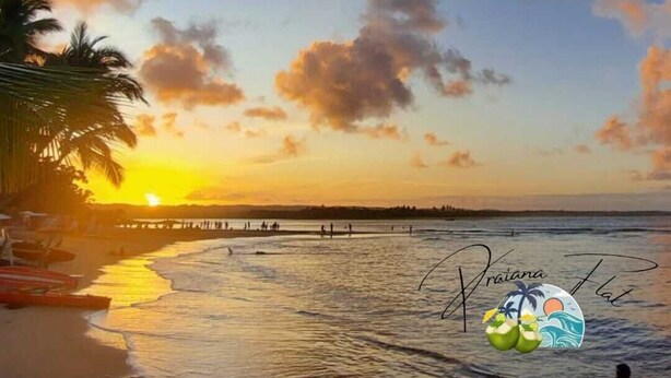A beach scene with a sunset, palm trees, and a pier. - Flat1 Complete 5 minutes from the Taipu de Fora Swimming Pools (Marau)