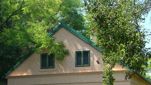 A two-story house with a green roof, a covered porch, and a well-maintained lawn. - Mikin dol Baranja Country House (Draz)