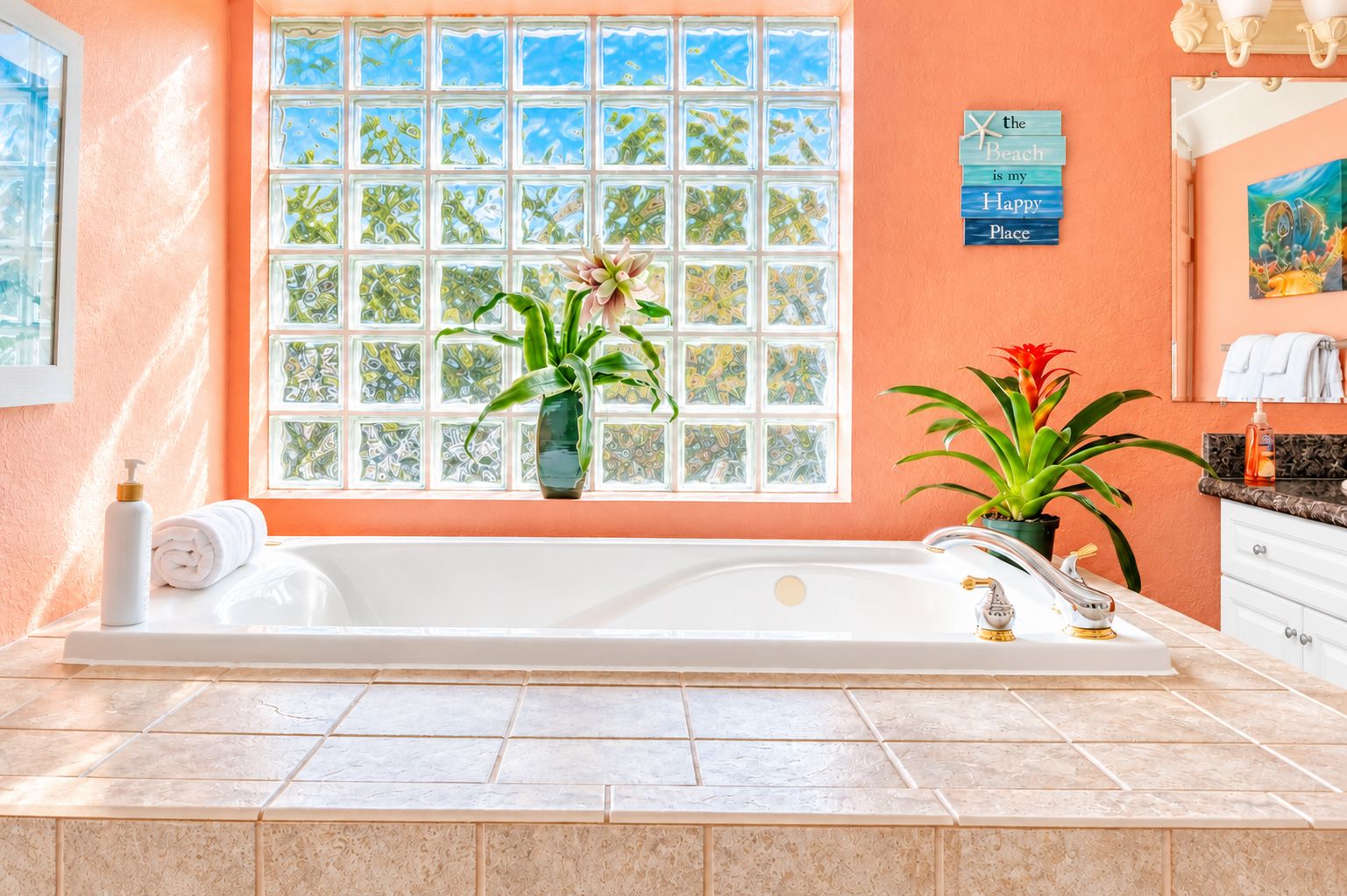 A bathroom with a large bathtub, a window with a view, and a towel dispenser.