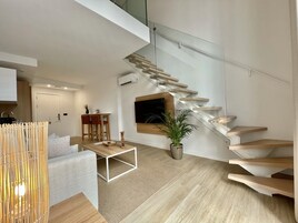 Deluxe Loft | Living area | 55-inch Smart TV with satellite channels, TV