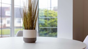 A round table with a potted plant in the center.